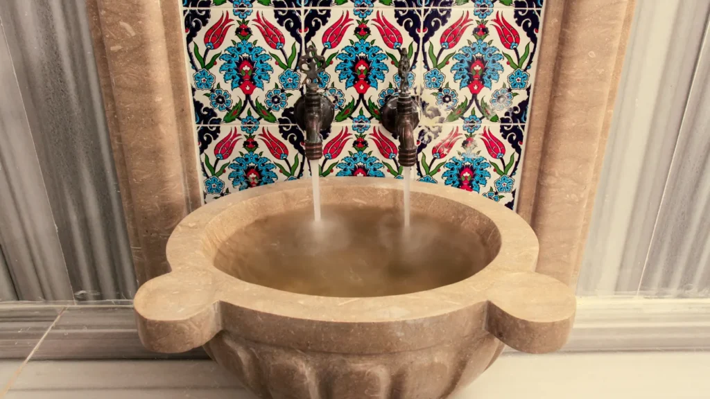Tourist receiving foam massage in marble hammam