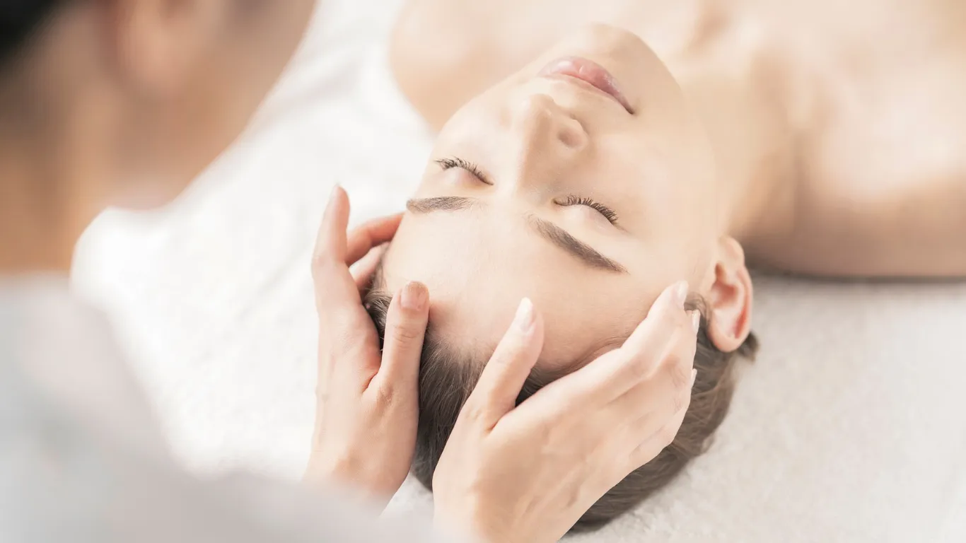 Therapist performing holistic massage at Victory Spa