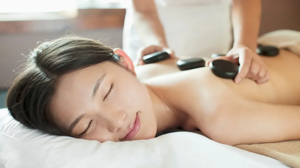 Hot stone massage therapy setup with essential oils