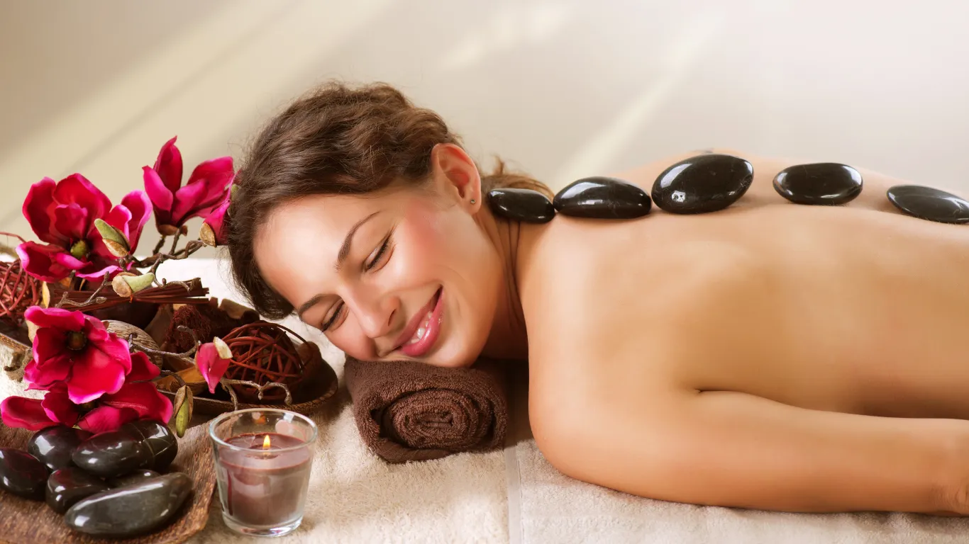 Basalt stones placed on client’s back during hot stone massage