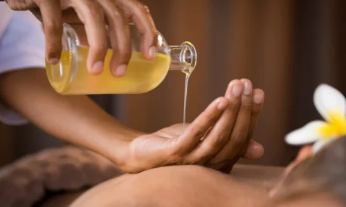 Client receiving aromatherapy massage with essential oils