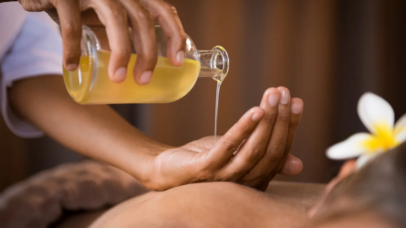 Client receiving aromatherapy massage with essential oils