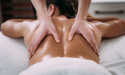Therapist applying deep tissue massage on lower back