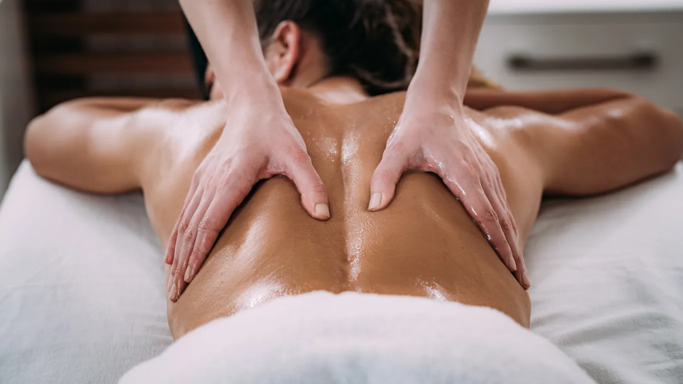 Therapist applying deep tissue massage on lower back