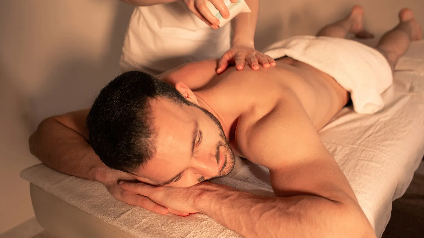 Therapist performing aromatherapy massage with essential oils