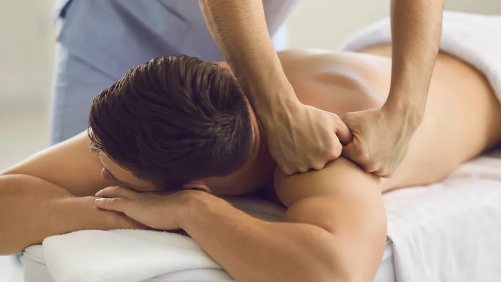 Luxury massage room with candles and rose petals