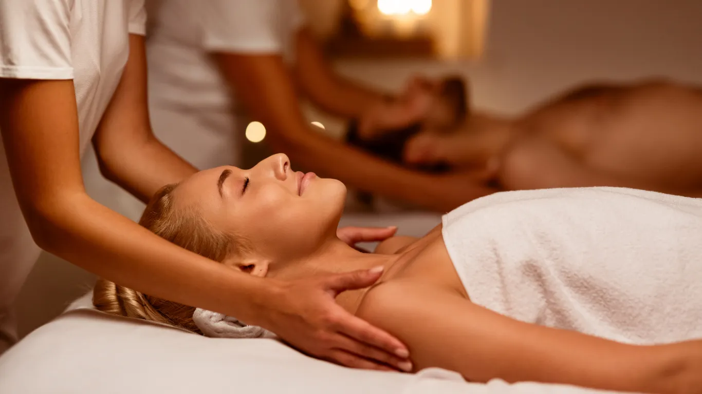 Couple receiving side-by-side massage at Victory Spa