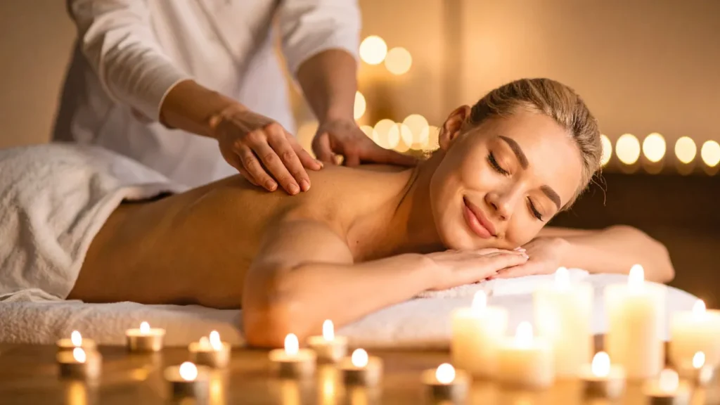 Therapist performing hot stone massage at Victory Spa