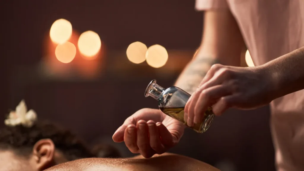Therapist preparing aromatherapy oils in spa room