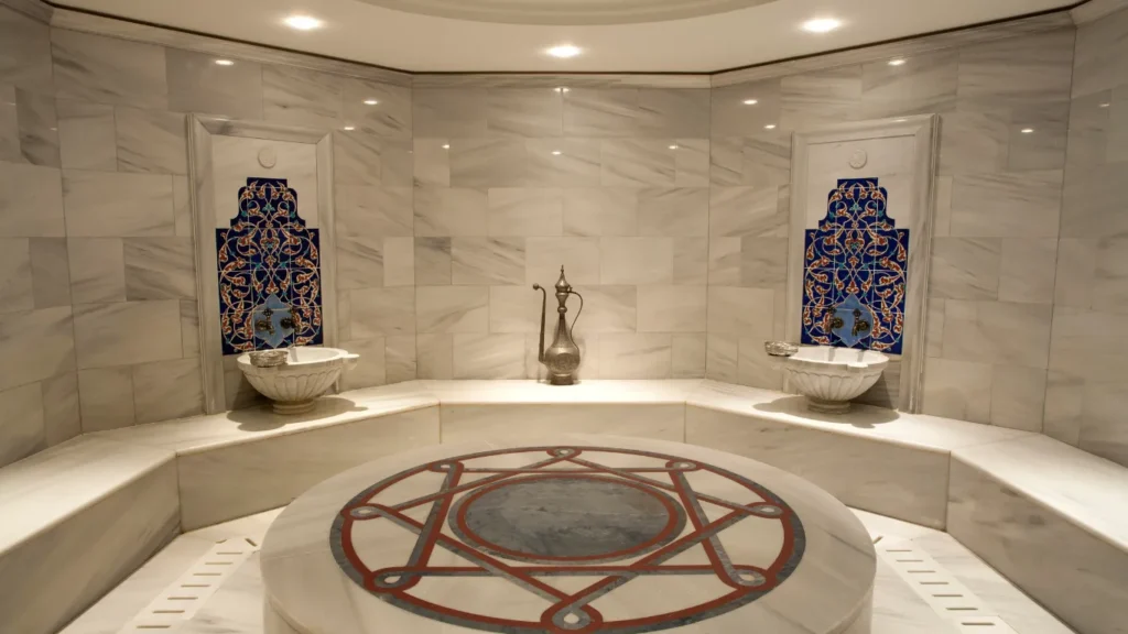 Therapist performing foam massage in a hammam.