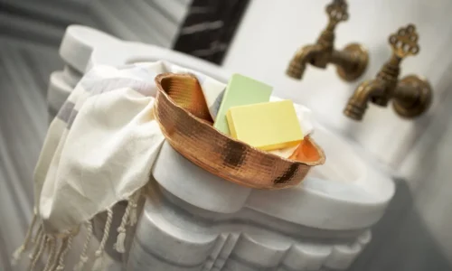 Elegant marble hammam suite with candlelight.