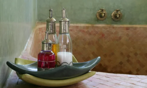 Private hammam room with marble and warm lighting.