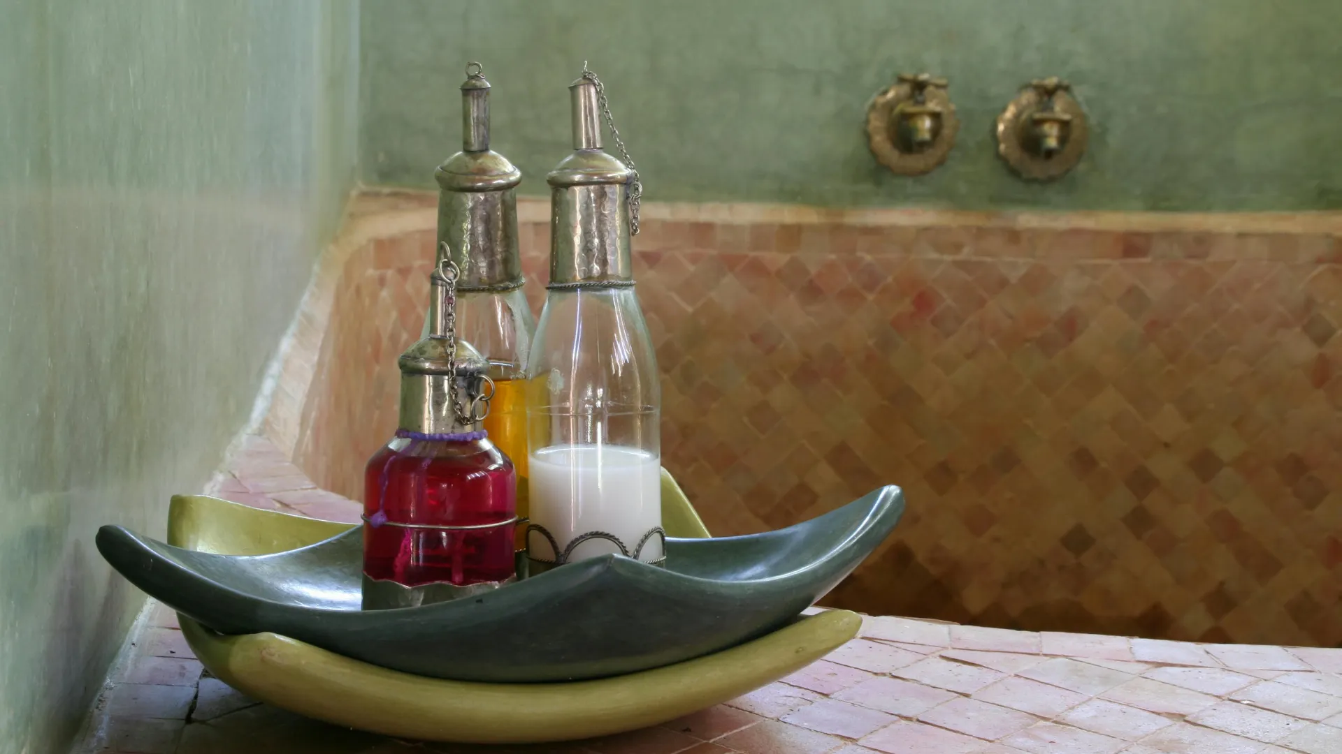 Private hammam room with marble and warm lighting.